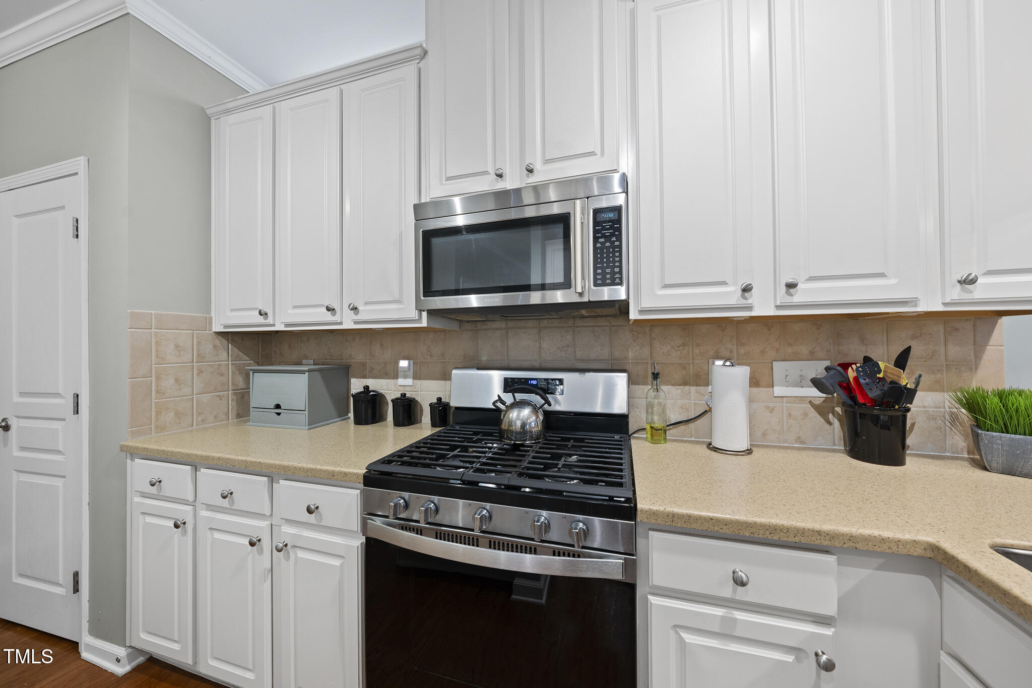 3419 Ranbir Drive Durham, NC 27713 - Photo 12 of 33 a kitchen with granite countertop white cabinets and stainless steel appliances