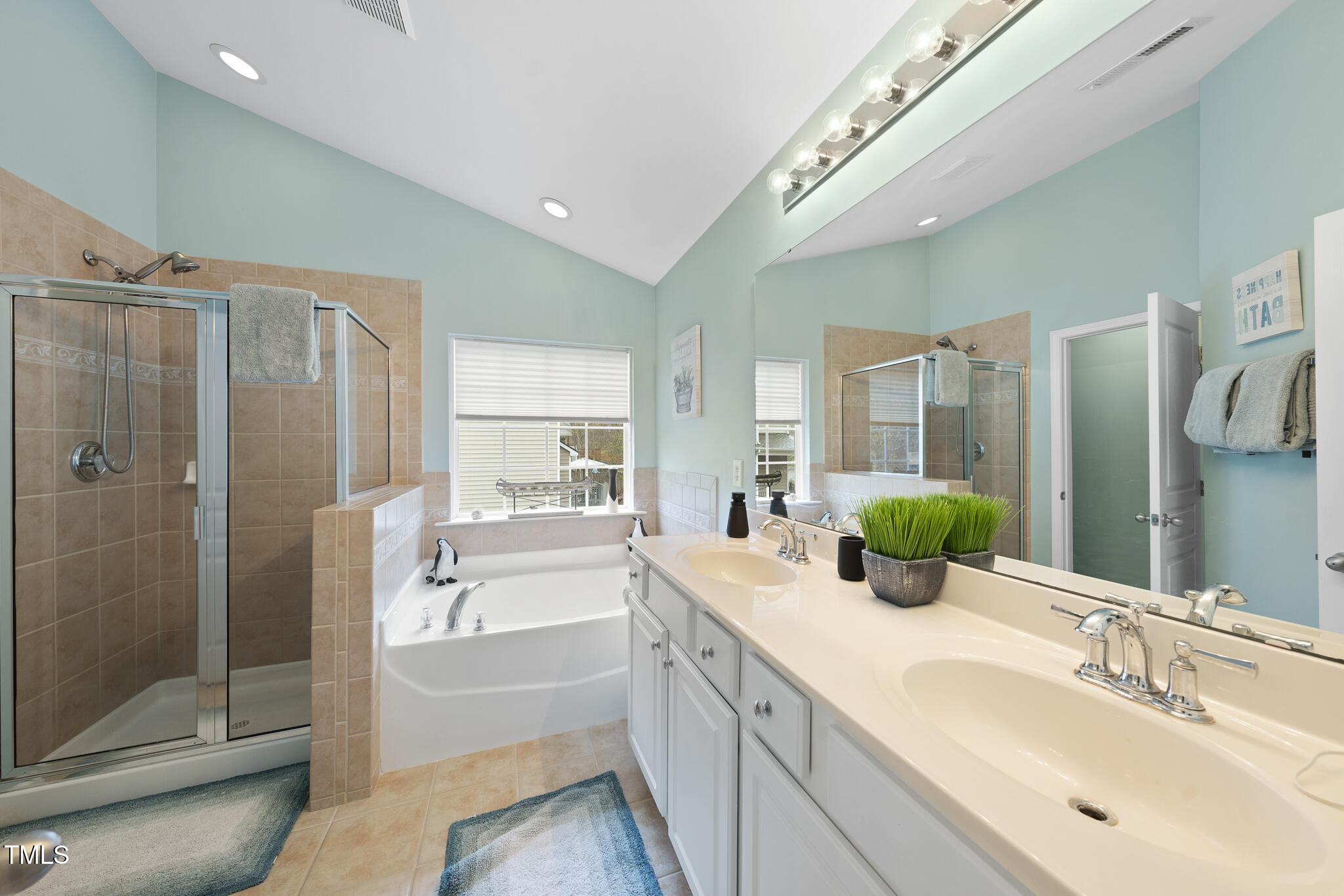 3419 Ranbir Drive Durham, NC 27713 - Photo 19 of 33 a spacious bathroom with a double vanity sink a large mirror a bathtub and shower