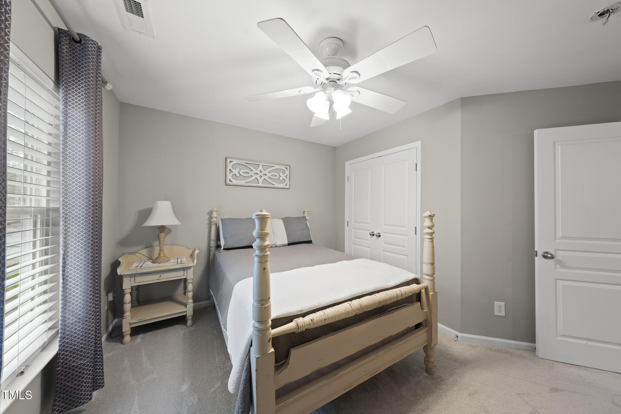 3419 Ranbir Drive Durham, NC 27713 - Photo 26 of 33 a bedroom with a bed and a chandelier