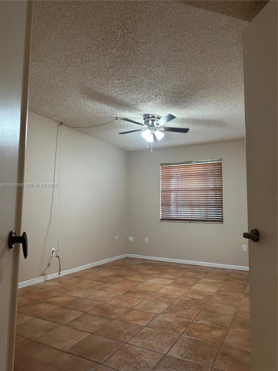 2653 Southeast 20th Court, Unit 105D Homestead, FL 33035 - Photo 11 of 16 a view of an empty room with a window