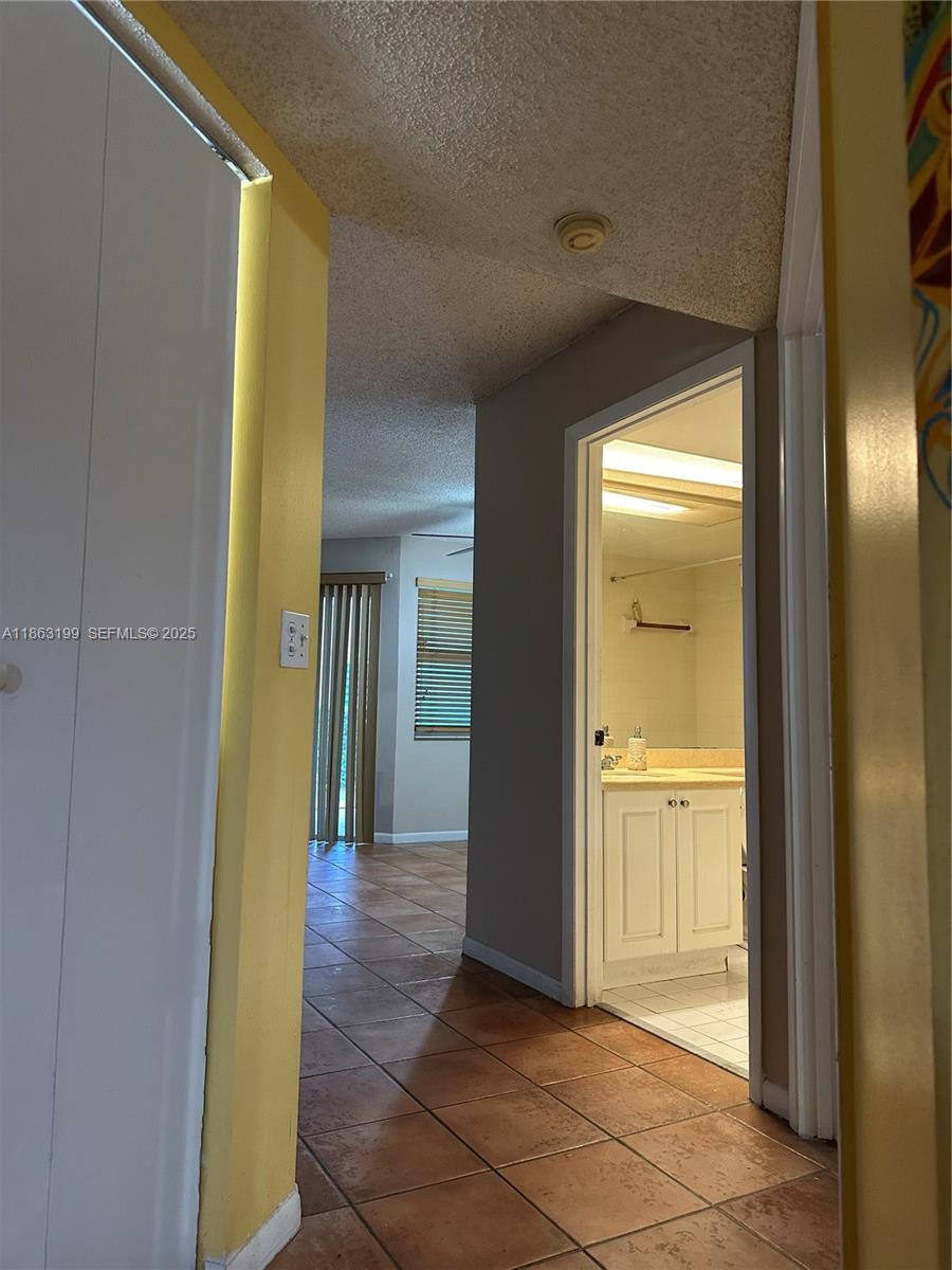 2653 Southeast 20th Court, Unit 105D Homestead, FL 33035 - Photo 12 of 16 a view of a hallway with wooden floor