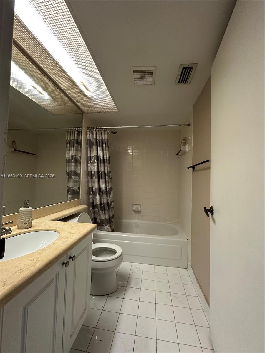 2653 Southeast 20th Court, Unit 105D Homestead, FL 33035 - Photo 4 of 16 a bathroom with a granite countertop sink a toilet and shower