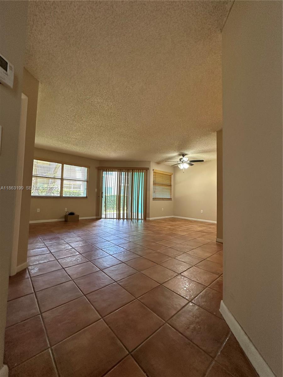 2653 Southeast 20th Court, Unit 105D Homestead, FL 33035 - Photo 7 of 16 a view of a livingroom with wooden floor and a window