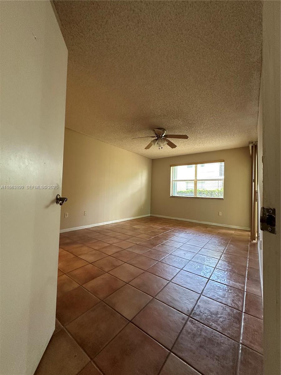 2653 Southeast 20th Court, Unit 105D Homestead, FL 33035 - Photo 8 of 16 a view of an empty room and window