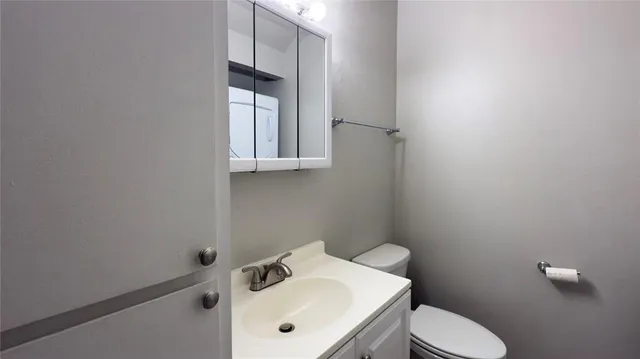 a bathroom with a sink toilet and mirror