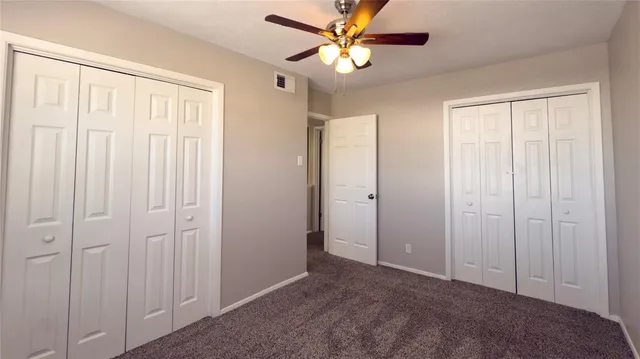 a view of a livingroom with a chandelier fan