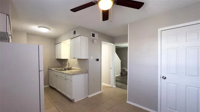 a kitchen with stainless steel appliances granite countertop a sink a stove and a refrigerator