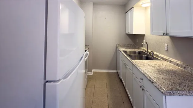 a kitchen with kitchen island granite countertop cabinets and window