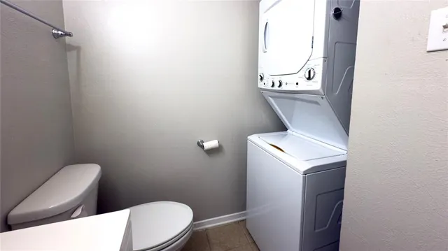 a bathroom with a toilet and a mirror
