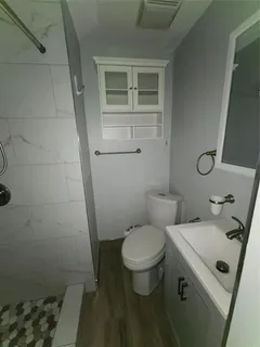 a bathroom with a sink toilet and shower