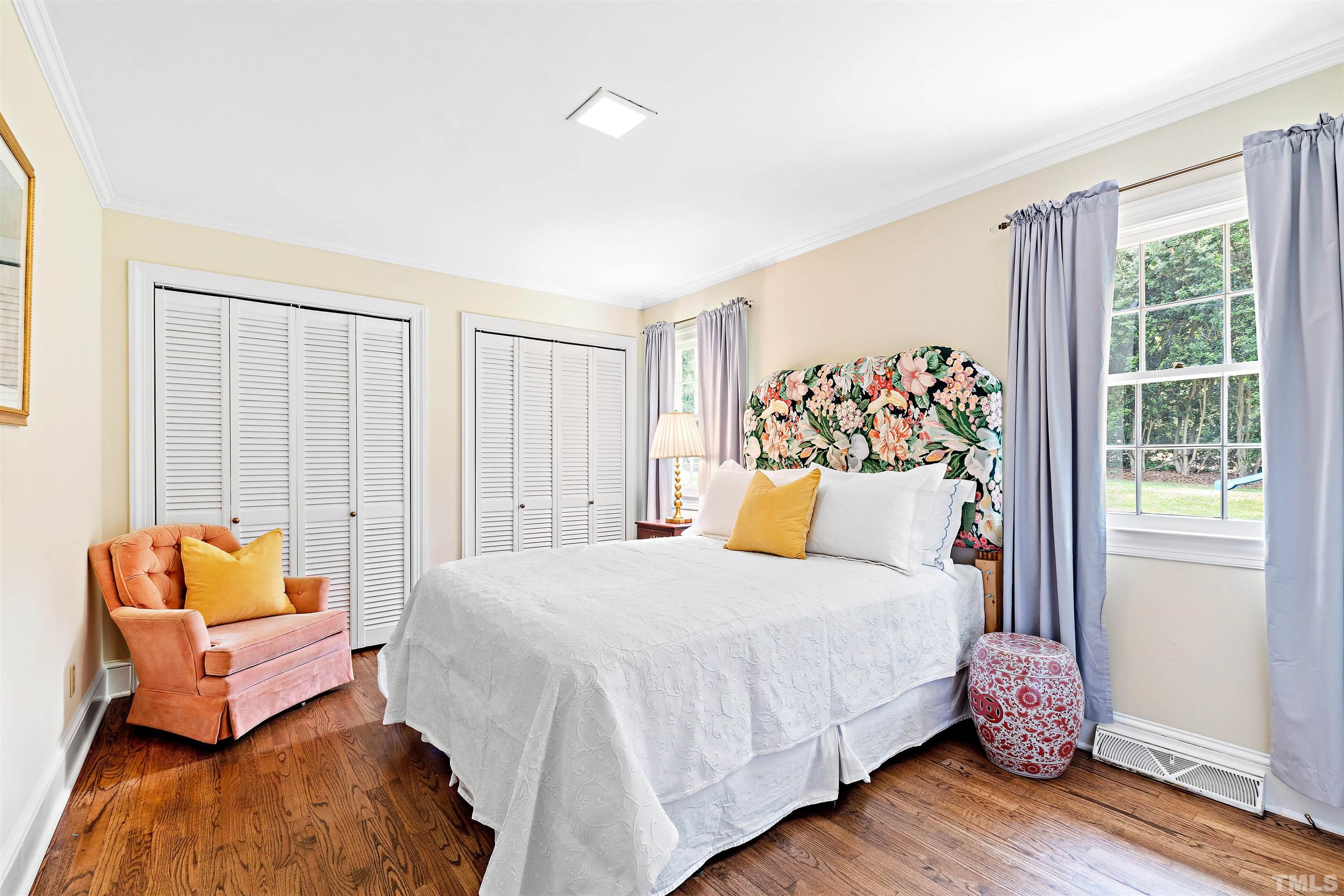 1205 Hunting Ridge Road Raleigh, NC 27615 - Photo 20 of 41 a bedroom with a bed and wooden floor