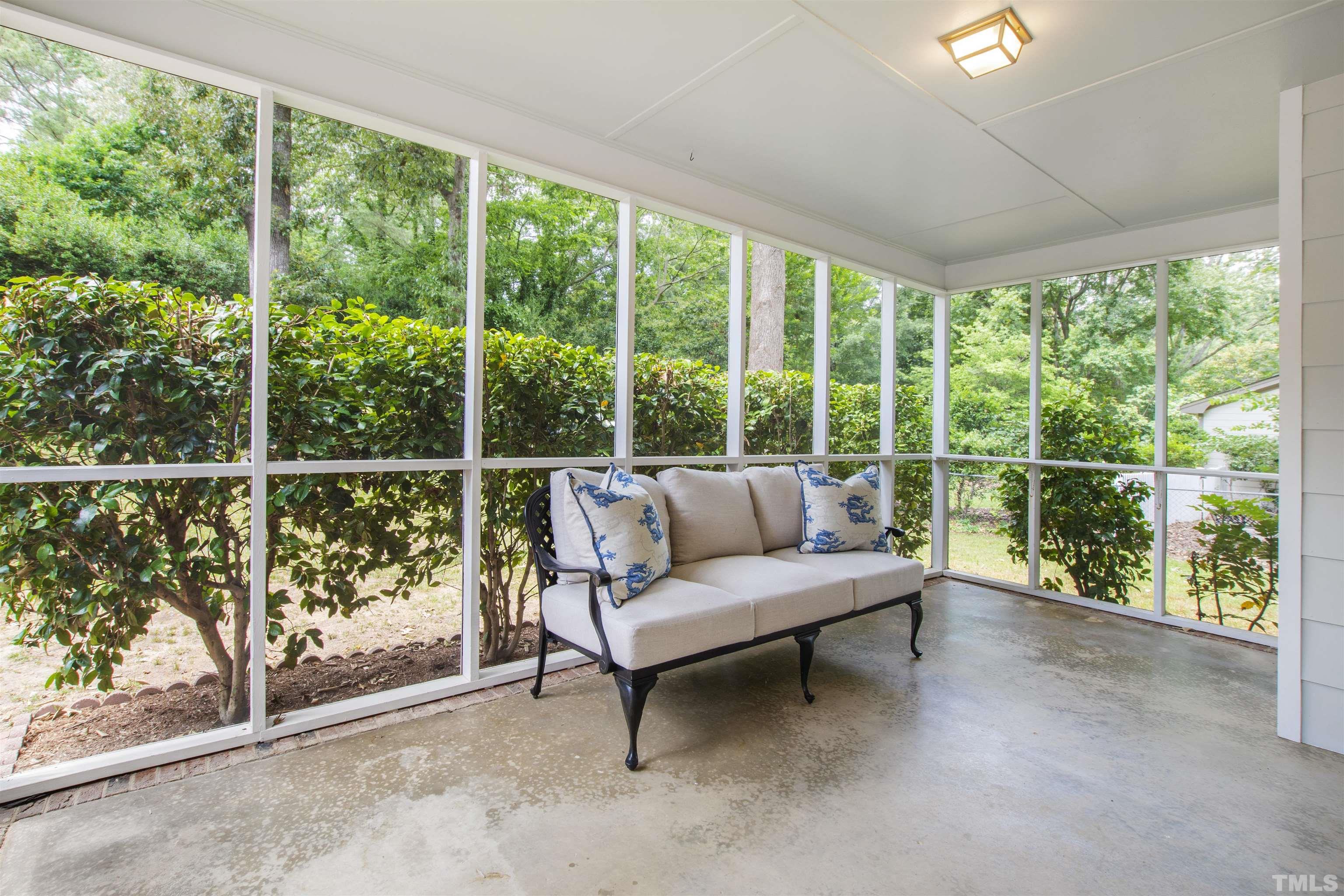 1205 Hunting Ridge Road Raleigh, NC 27615 - Photo 36 of 41 a living room with furniture and a floor to ceiling window