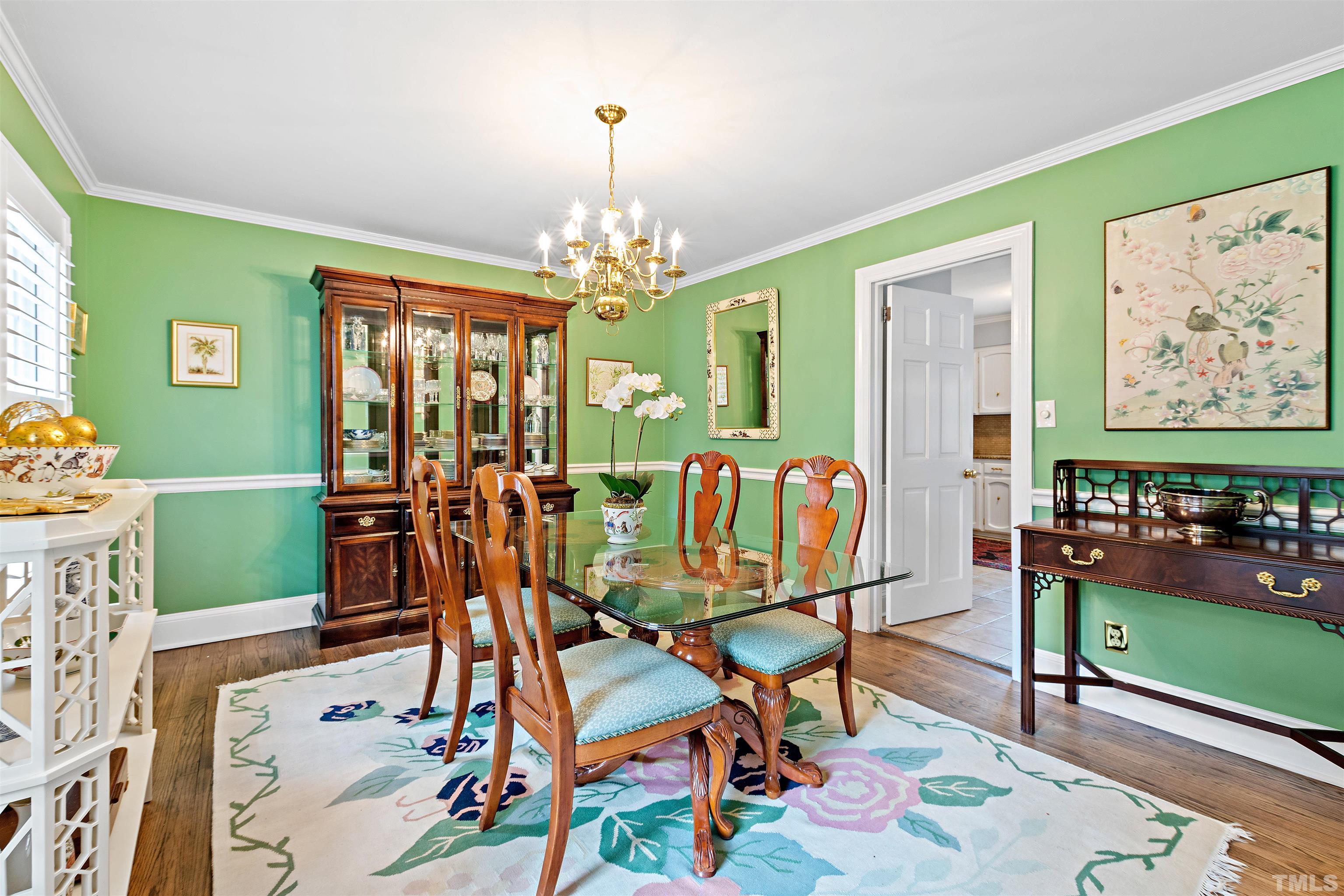 1205 Hunting Ridge Road Raleigh, NC 27615 - Photo 7 of 41 a view of a dining room with furniture and chandelier