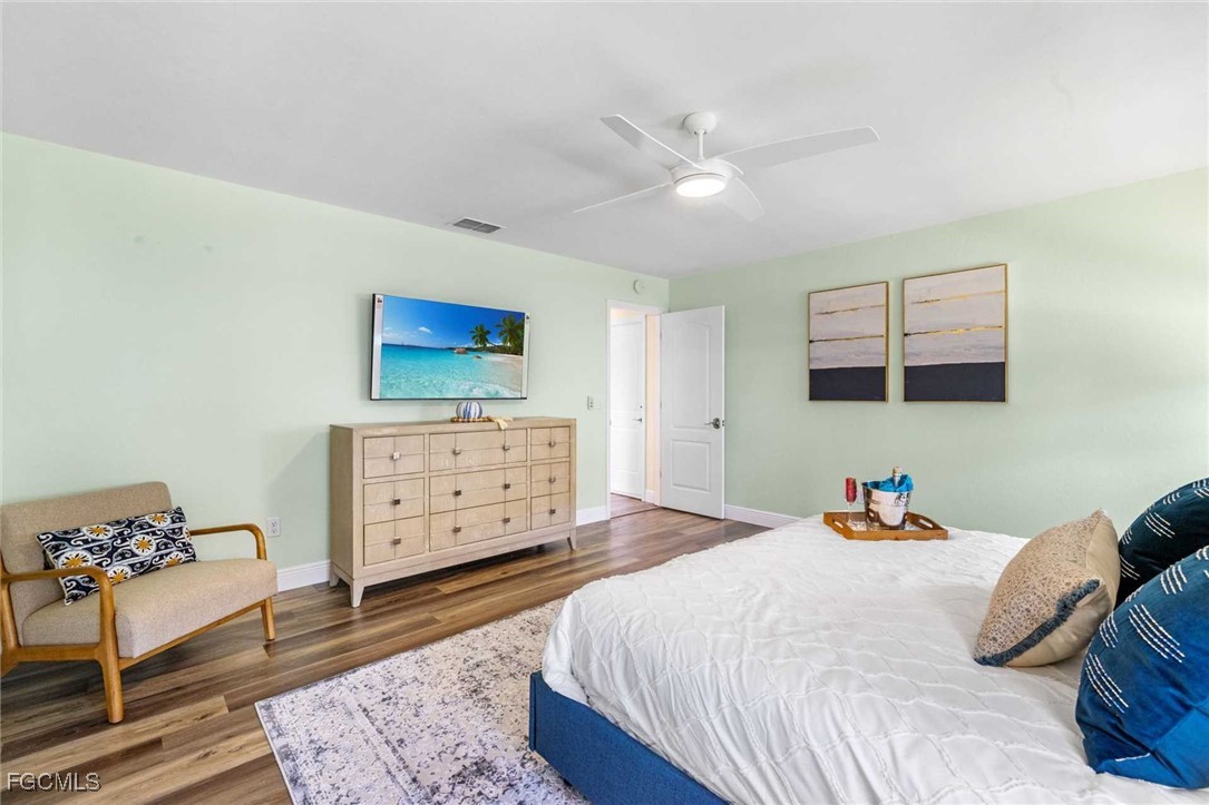 2307 Southwest 40th Street Cape Coral, FL 33914 - Photo 13 of 36 a bedroom with a bed and wooden floor