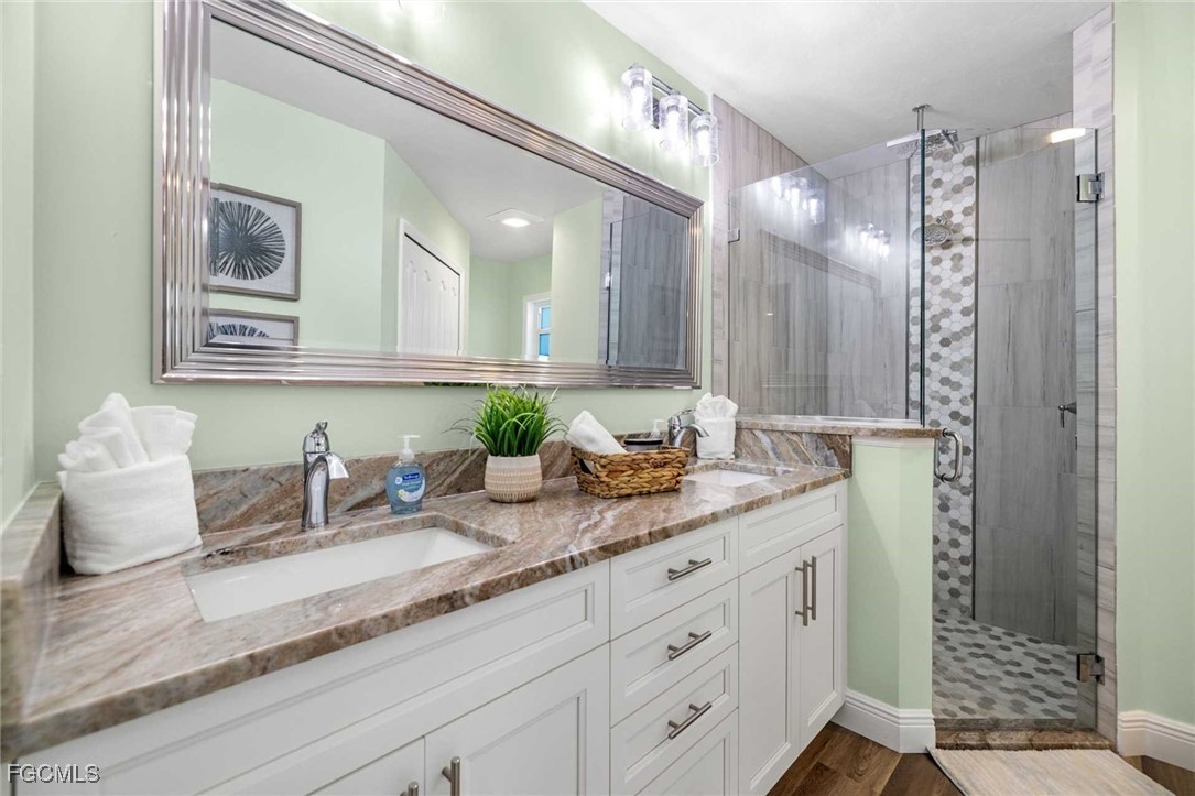 2307 Southwest 40th Street Cape Coral, FL 33914 - Photo 15 of 36 a bathroom with double vanity and a mirror