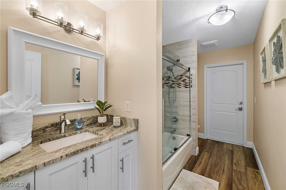 2307 Southwest 40th Street Cape Coral, FL 33914 - Photo 19 of 36 a bathroom with a granite countertop sink mirror and a bathtub