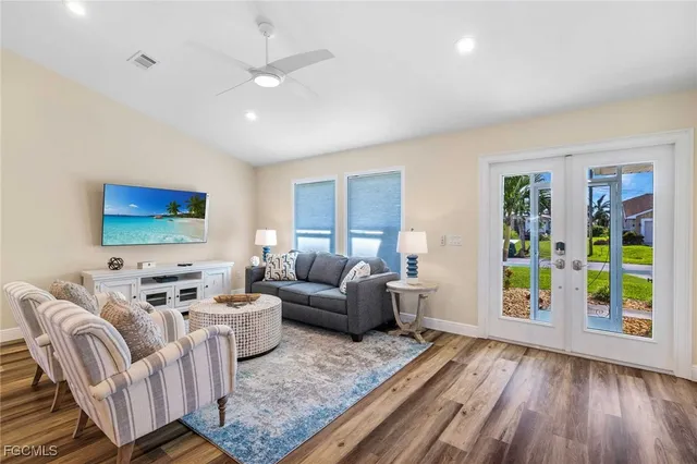 a living room with furniture and wooden floor