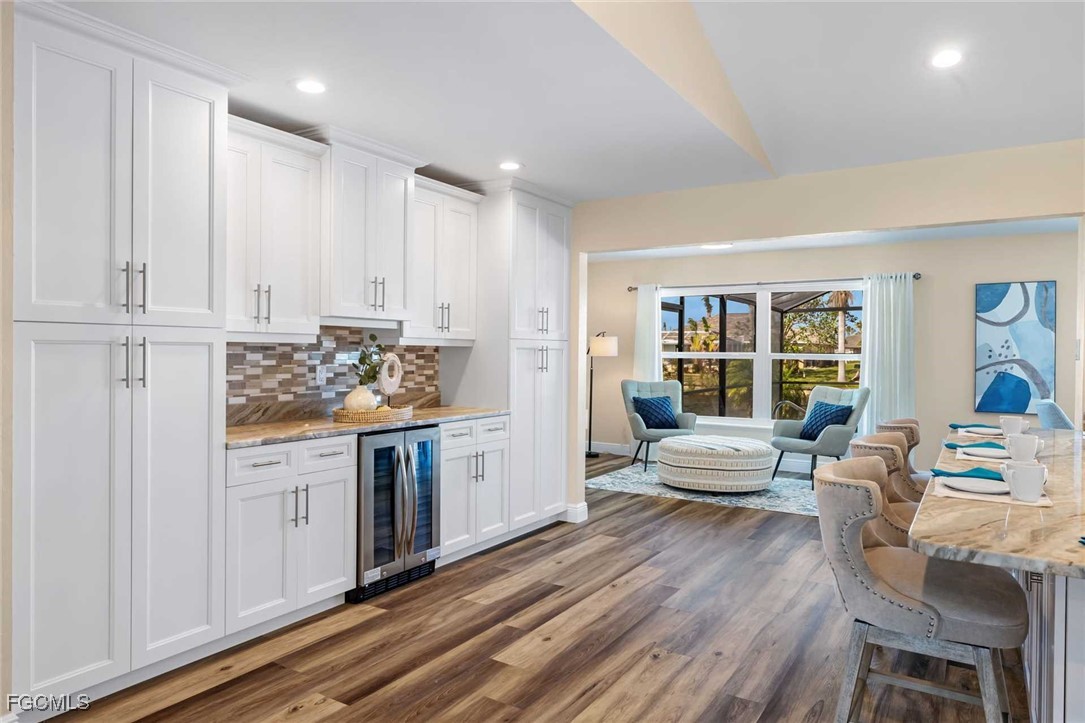 2307 Southwest 40th Street Cape Coral, FL 33914 - Photo 9 of 36 a kitchen with stainless steel appliances granite countertop a stove and white cabinets