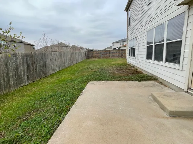 a view of a backyard with pathway