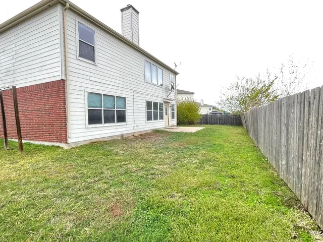 a view of a backyard with large trees