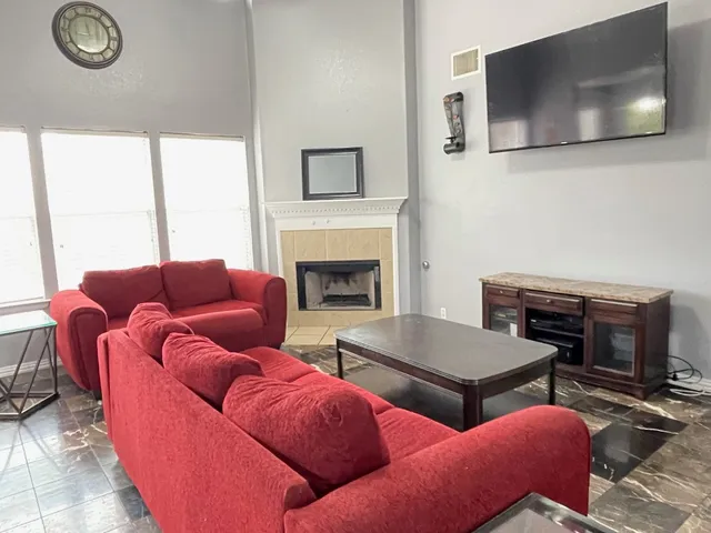 a living room with furniture and a fireplace