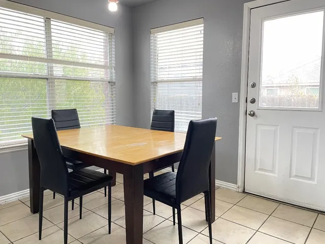 a view of a dining room with furniture and window