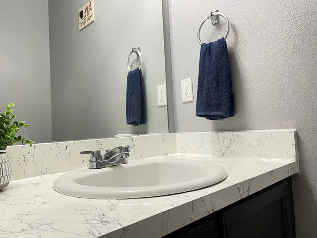 a bathroom with a sink and a mirror