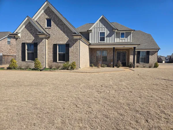 a front view of a house with a yard