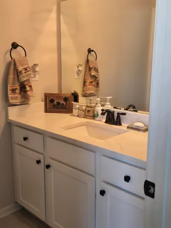 a bathroom with a sink and mirror