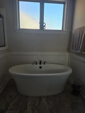 a white bath tub sitting in a bathroom