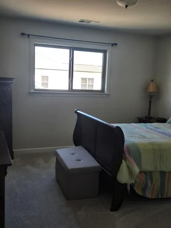 a bedroom with a bed and window
