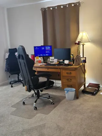 a workspace with furniture and a lamp