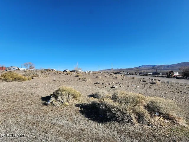 a view of mountain view and covered with snow in the background