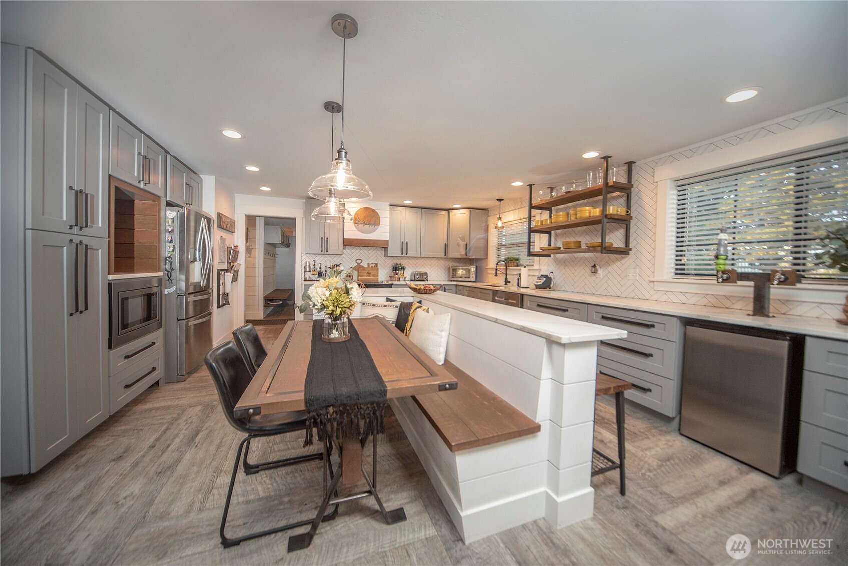 110 Brown Road Ellensburg, WA 98926 - Photo 10 of 40 a kitchen with stainless steel appliances a dining table chairs sink and wooden floor