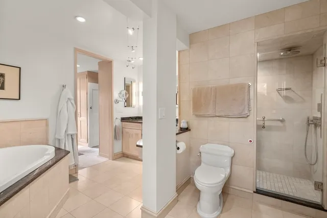 a bathroom with a tub toilet and shower