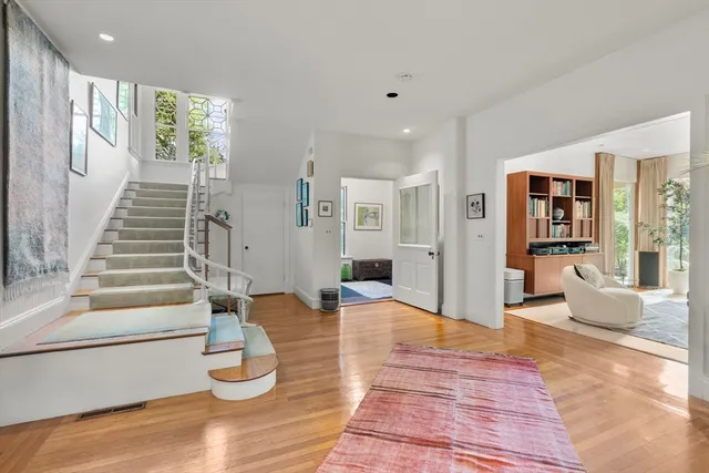 a view of an entryway with wooden floor and windows