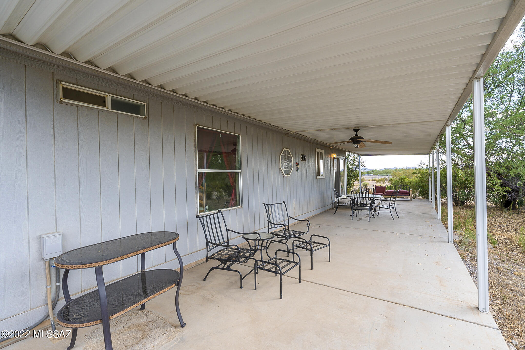 5285 North Puma Road Marana, AZ 85653 - Photo 37 of 46 a view of a patio with table and chairs potted plants with large tree