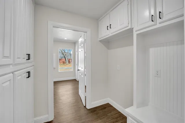 a view of an empty room and wooden floor