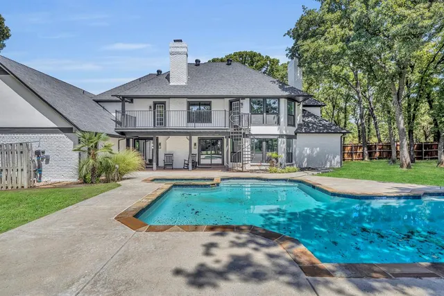 a front view of a house with swimming pool having outdoor seating