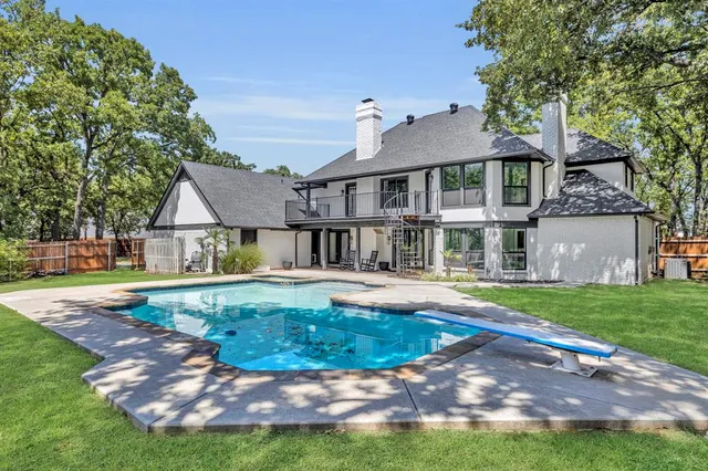 a view of a house with swimming pool and a yard
