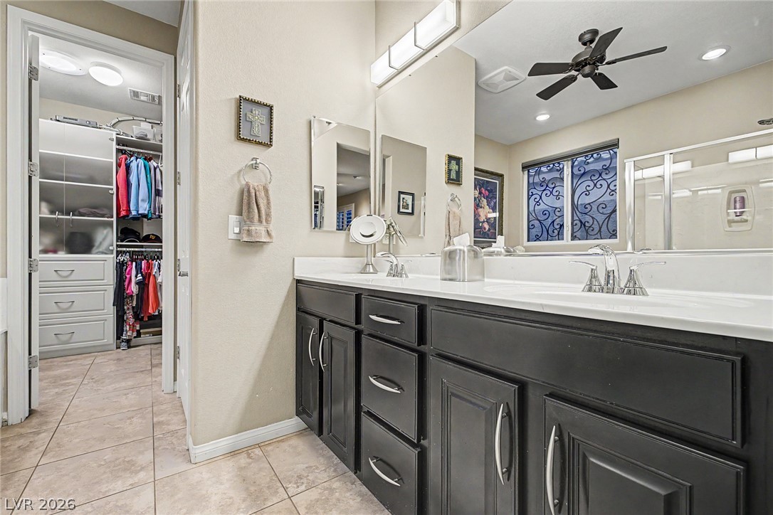 7415 Campbell Ranch Avenue Las Vegas, NV 89179 - Photo 33 of 52 Double vanity sinks and an adjacent walk-in closet create a functional and organized primary bathroom retreat.