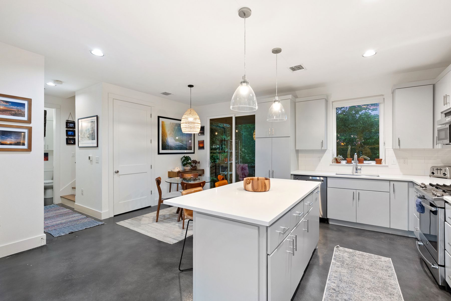 1709 Perez Street, Unit 2 Austin, TX 78721 - Photo 12 of 33 A modern kitchen design with a functional island and seamless outdoor access.