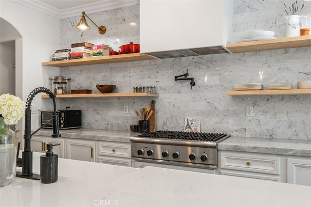 a kitchen with stainless steel appliances granite countertop a sink and cabinets