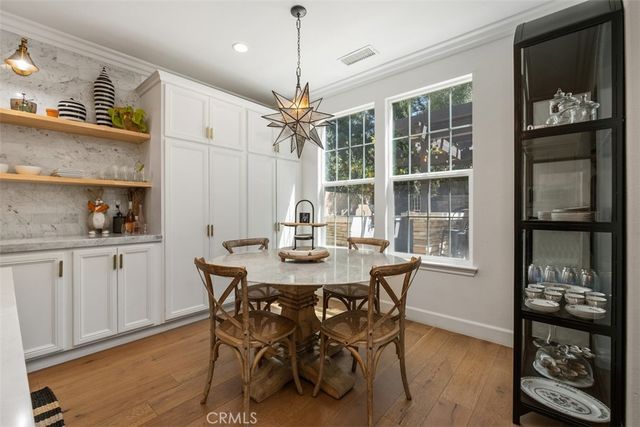 a view of a dining room with furniture kitchen and wooden floor