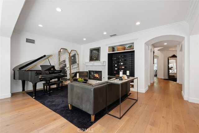 a living room with fireplace furniture and a wooden floor