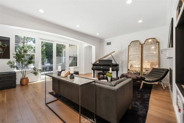 a living room with furniture and floor to ceiling windows