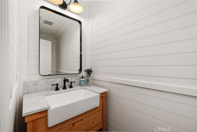 a bathroom with a sink vanity and a mirror