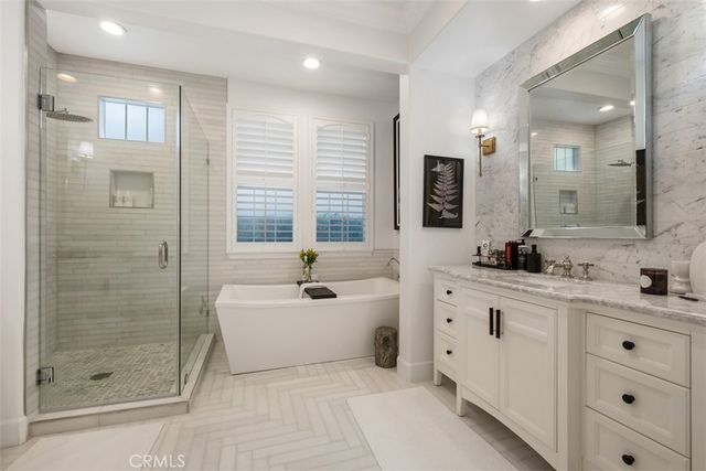 a spacious bathroom with a shower sink and mirror