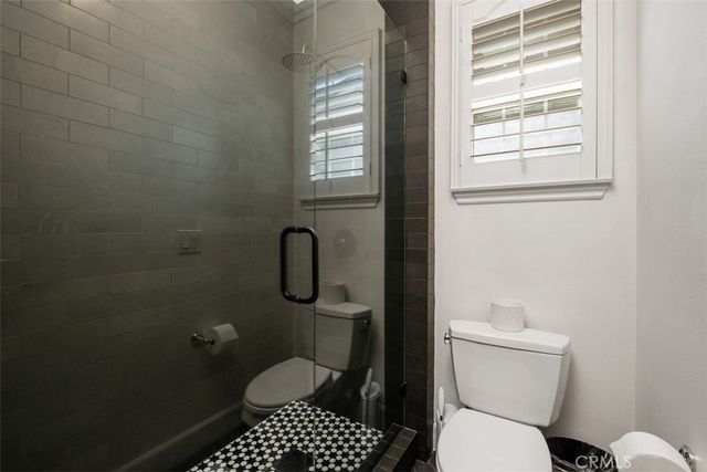 a bedroom with bed couch and window