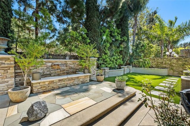 a view of a swimming pool with a lounge chair and grass